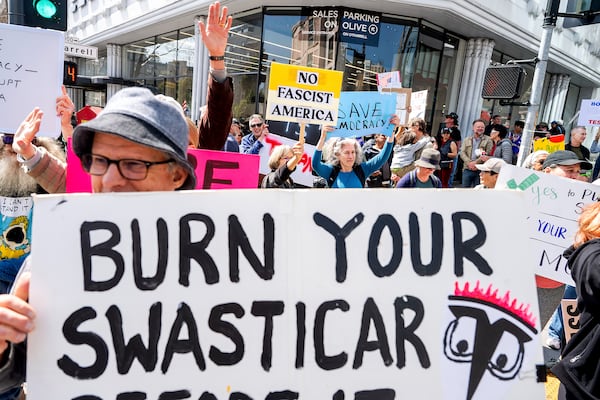 Protesters rally against Tesla CEO Elon Musk outside a Tesla store in San Francisco on Saturday, March 29, 2025. (AP Photo/Noah Berger)