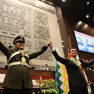 President Rodrigo Paz, right, and Vice President Edman Lara hold hands after the swearing-in ceremony in La Paz, Bolivia, Saturday, Nov. 8, 2025. (Luis Gandarillas, Pool Photo via AP)