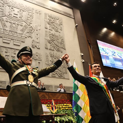 President Rodrigo Paz, right, and Vice President Edman Lara hold hands after the swearing-in ceremony in La Paz, Bolivia, Saturday, Nov. 8, 2025. (Luis Gandarillas, Pool Photo via AP)