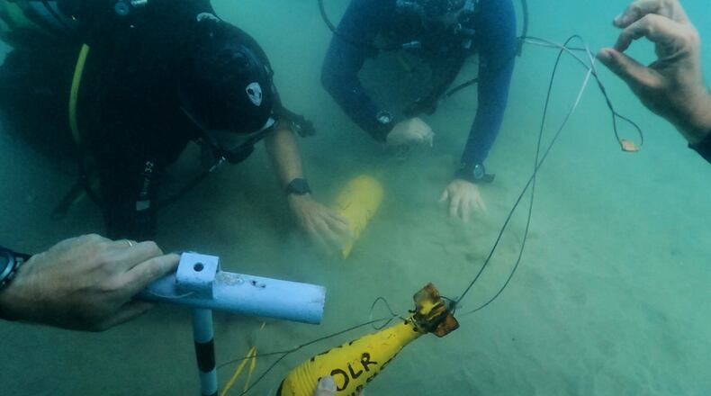 Divers place mock munitions on the floor of the Mediterranean Sea off the coast of Rishon LeZion, Israel, Sunday, June 21, 2026. (AP Photo/Sam Mednick)