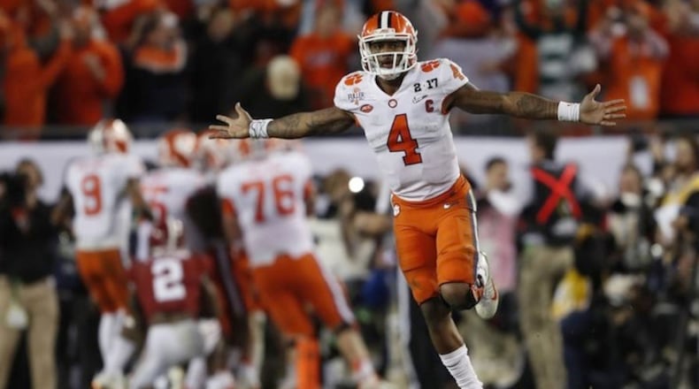 Clemson's Deshaun Watson celebrates a last second touchdown pass to Hunter Renfrow in the second half of the NCAA college football playoff championship game against Alabama in Tampa, Fla.