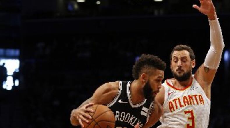 Allen Crabbe got the best of the Hawks early but Marco Belinelli answered late. (AP Photo)