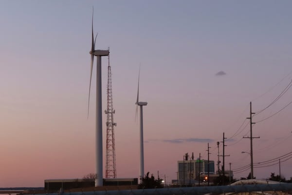 FILE - The sun sets behind a land-based wind farm in Atlantic City, N.J., on Feb. 10, 2022. (AP Photo/Wayne Parry, File)