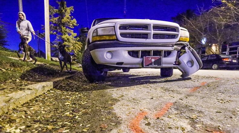 A woman died after being run over by a vehicle that also hit this SUV parked along Arizona Avenue in northeast Atlanta on Nov. 11, 2015.