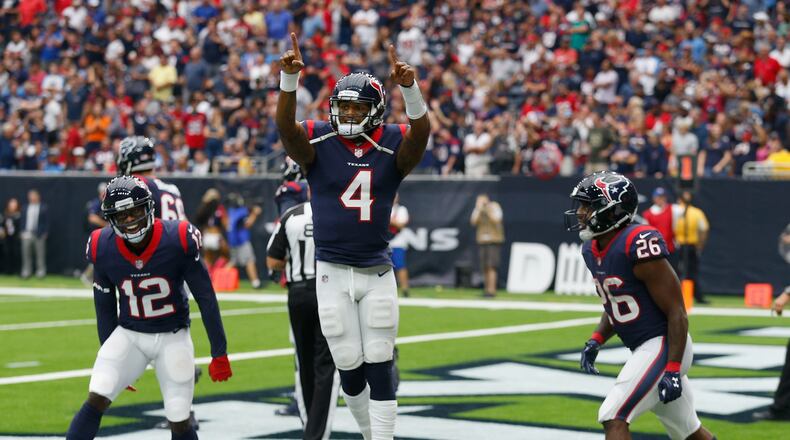 Texans rookie quarterback Deshaun Watson celebrates with Bruce Ellington #12 and Lamar Miller #26 after scoring on a one-yard run in the second quarter against the Titans at NRG Stadium on Sunday in Houston.