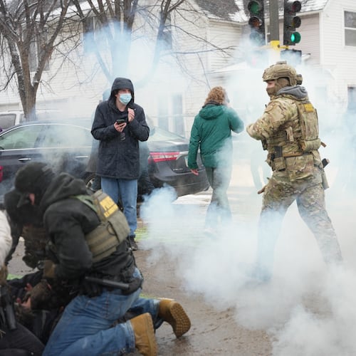 Tear gas is deployed as Federal agents make arrests on Wednesday, Jan. 21, 2026, in Minneapolis. (AP Photo/Angelina Katsanis)