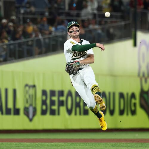 FILE - Athletics shortstop Jacob Wilson throws to first base during the seventh inning of a baseball game against the Kansas City Royals in West Sacramento, Calif., Sept. 27, 2025. (AP Photo/Sara Nevis, File)