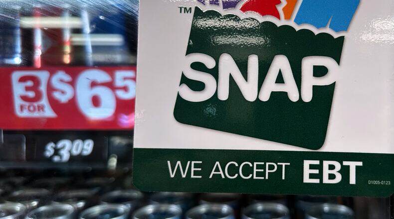 FILE - SNAP EBT information sign is displayed at a gas station in Riverwoods, Ill., Nov. 1, 2025. (AP Photo/Nam Y. Huh, File)