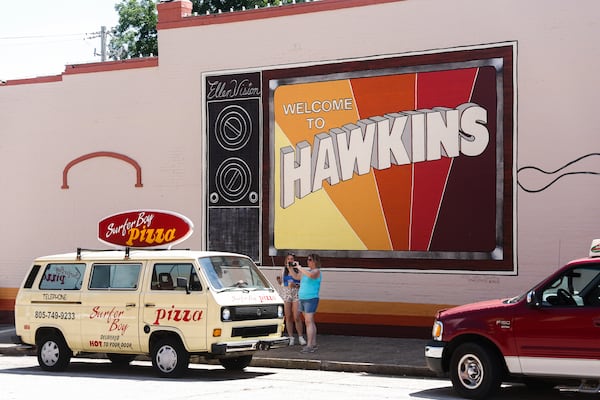 Tourists take a photo of a van from the hit television show "Stranger Things" in Jackson, on Saturday, June 6, 2026. (Abbey Cutrer/AJC)