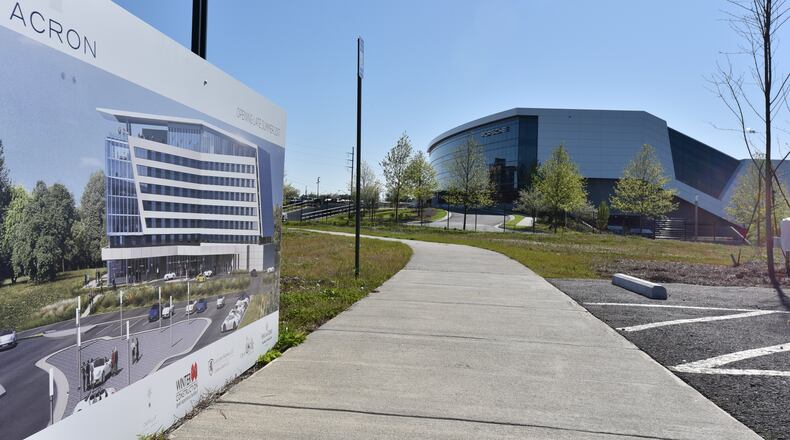 April 5, 2016 Hapeville - With the Porsche Experience Center in the background, future Solis Hotel picture is displayed during a groundbreaking ceremony for Solis Hotel Two Porsche Drive next to the Porsche Experience Center on Tuesday, April5, 2016. The rise of the high-end hotel Solis next to the Porsche North America headquarters marks one of the highest-profile hopes that the dream of an aerotropolis could be possible. Southside businesses, political and community leaders have long-held onto the idea that the airport area could become a thriving business district like Buckhead or Perimeter. HYOSUB SHIN / HSHIN@AJC.COM