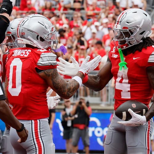 Ohio State wide receiver Jeremiah Smith, right, celebrates his touchdown reception against Ball State with teammate Brandon Inniss during the first half of an NCAA college football game, Saturday, Sept. 5, 2026, in Columbus, Ohio. (AP Photo/Jay LaPrete)