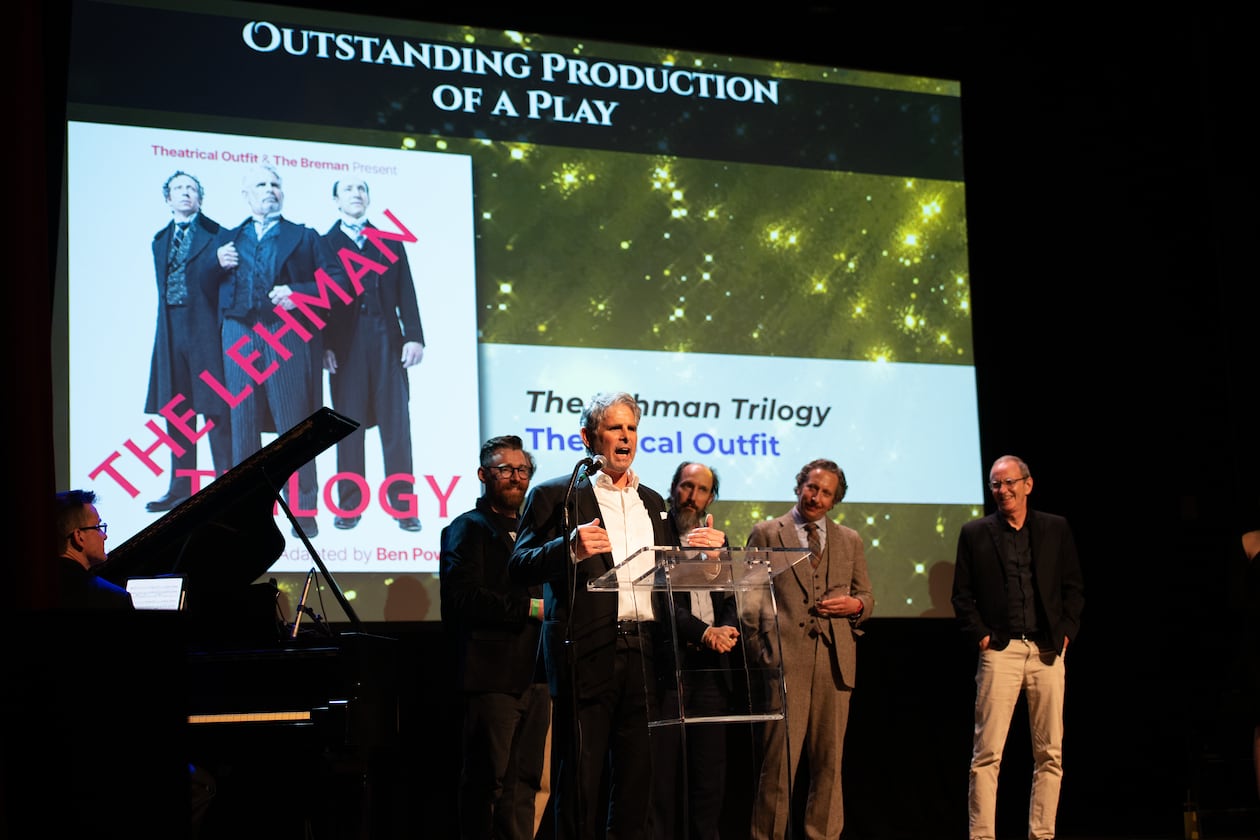 Theatrical Outfit, with actor Brian Kurlander speaking, accepts the Outstanding Play prize for "The Lehman Trilogy" at the 20th Suzi Bass Awards, Atlanta's version of the Tony Awards. (Courtesy of Robert Mitchel Owenby)