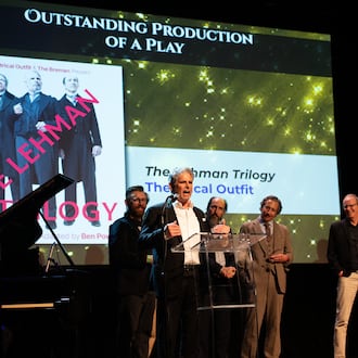 Theatrical Outfit, with actor Brian Kurlander speaking, accepts the Outstanding Play prize for "The Lehman Trilogy" at the 20th Suzi Bass Awards, Atlanta's version of the Tony Awards. (Courtesy of Robert Mitchel Owenby)