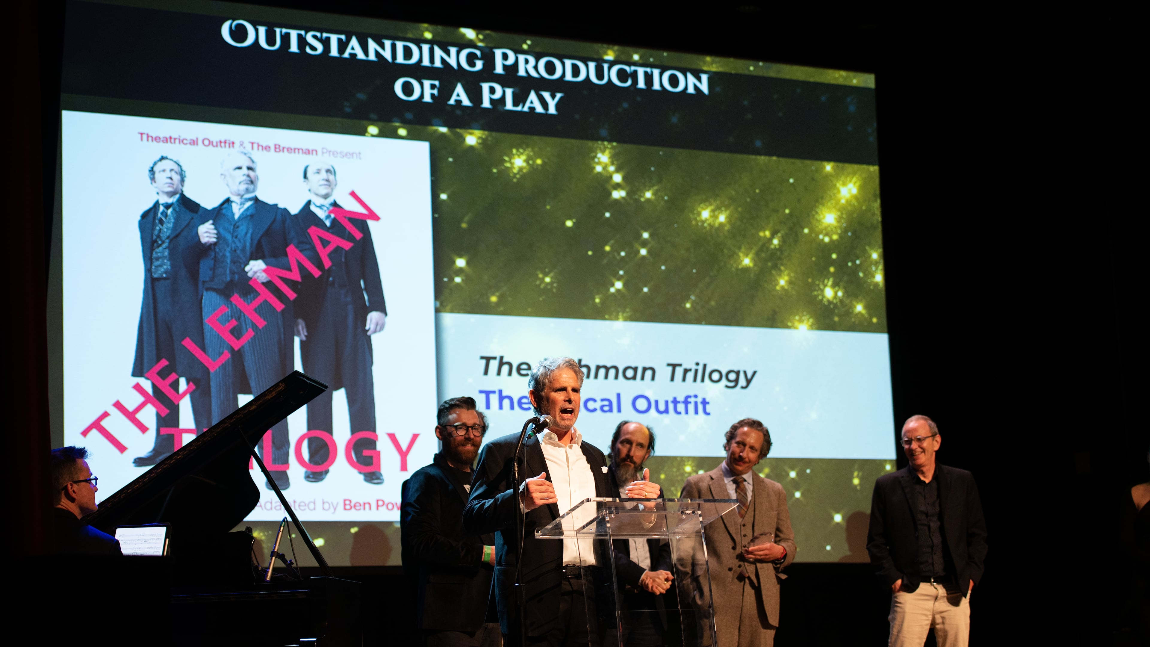 Theatrical Outfit, with actor Brian Kurlander speaking, accepts the Outstanding Play prize for "The Lehman Trilogy" at the 20th Suzi Bass Awards, Atlanta's version of the Tony Awards. (Courtesy of Robert Mitchel Owenby)