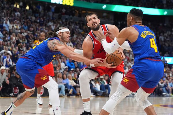 Los Angeles Clippers center Ivica Zubac, center, goes up for a basket between Denver Nuggets forward Aaron Gordon, left, and guard Russell Westbrook in the second half of Game 1 of an NBA first-round playoff series Saturday, April 19, 2025, in Denver. (AP Photo/David Zalubowski)