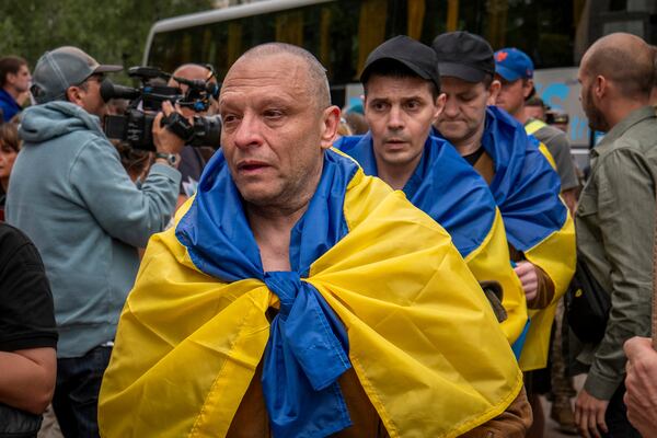 Ukrainian soldier reacts after returning from captivity after a POWs exchange between Russia and Ukraine in Chernyhiv region, Ukraine, Thursday, June 19, 2025. (AP Photo/Dan Bashakov)