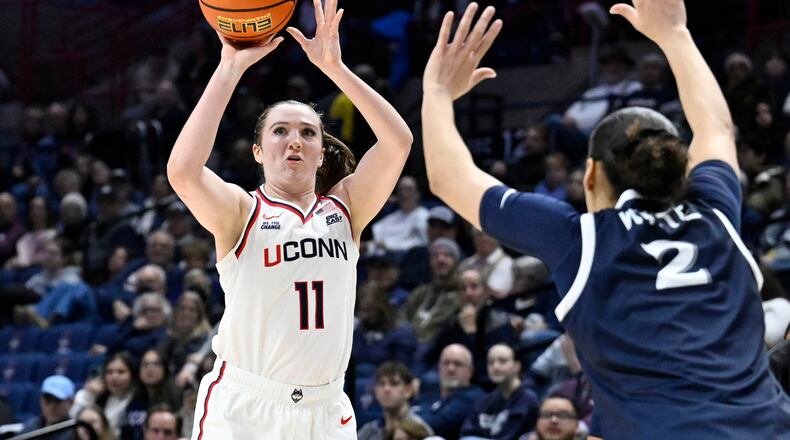 UConn guard Allie Ziebell (11) shoots as Xavier guard Savannah White (2) defends in the first half of an NCAA college basketball game, Wednesday, Jan. 28, 2026, in Storrs, Conn. (AP Photo/Jessica Hill)