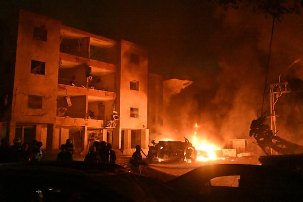 Firefighters work to extinguish a blaze after a missile launched from Iran struck Haifa, in northern Israel, on Sunday, June 15, 2025. (AP Photo/Rami Shlush)