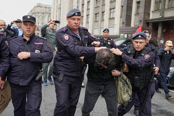 Police detain an activist during a picket against internet limitations in front of The State Duma, the lower house of the Russian Parliament, prior to consider the third and final reading of a bill, criminalising the search of "extremist materials" in Moscow, Russia, Tuesday, July 22, 2025. (AP Photo)