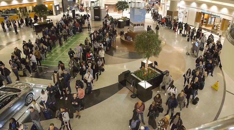 Multiple security lines at Hartsfield-Jackson International Airport ran across the atrium then snaked through baggage claim in both domestic terminals on Monday February 4th, 2019. Official expected over 100,00 travelers to pass through the airport today. (Photo by Phil Skinner)