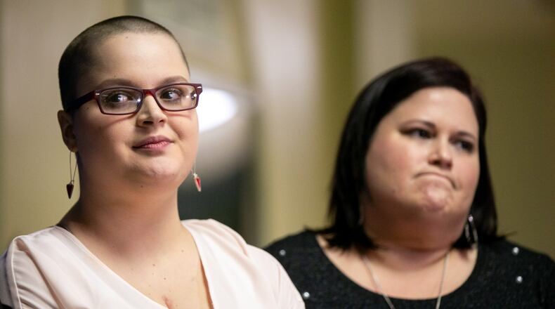 Hailie Massey, left, and her mother Laurie Wilson stand together during a press conference at the Georgia Capitol on Thursday. “The speaker used his powers to grant legislative leave for fancy dinners and fundraising for his campaign instead of trying my child’s rape case,” Wilson said. REBECCA WRIGHT / FOR THE AJC