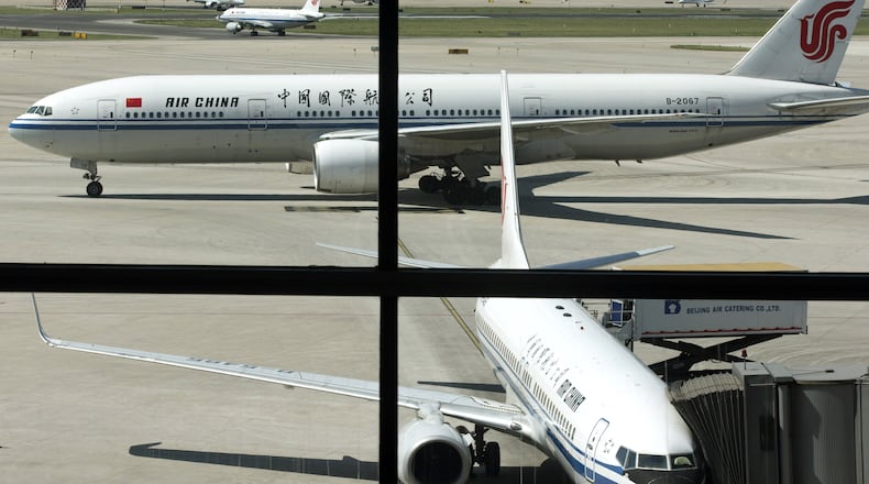In this Sept. 5, 2013 file photo, an Air China’s Boeing 777 jet, top, taxis to a gate after landing at Beijing International Airport in Beijing, China. Air China said Thursday, Sept. 8, 2016, that it had removed copies of its inflight magazine containing an article telling visitors to take precautions when visiting areas of London with large ethnic-minority populations. The state-owned airline, China’s flag carrier, said in an e-mail to The Associated Press that the September issue of “Wings of China” used “inappropriate” language and that the article didn’t represent the airline’s views. (AP Photo/Alexander F. Yuan, File)