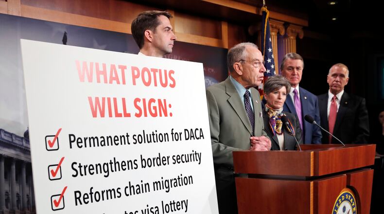 Sen. Chuck Grassley, R-Iowa, second from left, speaks accompanied by Sen. Tom Cotton, R-Ark., left, Sen. Joni Ernst, R-Iowa, Sen. David Perdue, R-Ga., and Sen. Thom Tillis, R-N.C., during a news conference about an immigration bill on Capitol Hill, Monday, Feb. 12, 2018 in Washington. (AP Photo/Alex Brandon)