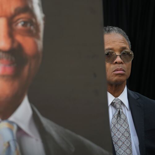 Jesse Jackson, Jr. stands near a picture of his father, the late Rev. Jesse Jackson, during a news conference outside the family home in Chicago, Wednesday, Feb. 18, 2026. (AP Photo/Erin Hooley)