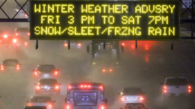 ATLANTA: Motorists make their way on northbound I-85 after the Brookwood exchange where a GDOT signboard warned about the winter advisory on Friday, Jan. 22, 2016 in Atlanta. Some schools were closed, others had early dismissals and the governor declared a state of emergency in 21 counties ahead of a system that may dump as much as 2 inches of snow in metro Atlanta and more than a foot in higher elevations in north Georgia. Wet conditions Friday morning led to downed trees and crashes throughout metro Atlanta, according to the WSB 24-hour Traffic Center. A winter weather advisory for accumulating snow and ice will be in effect from 3 p.m. Friday through 7 p.m. Saturday for metro Atlanta, and a winter storm warning for far north Georgia through 7 p.m. Saturday, according to Channel 2 meteorologists. Meteorologist Brian Monahan said, “This is all part of the same storm that will bring feet of snow to Washington, D.C.” JOHN SPINK /JSPINK@AJC.COM