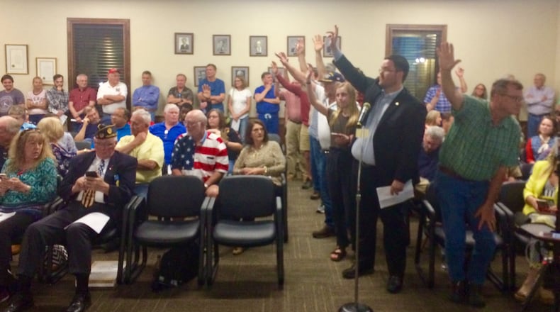 A crowd of unhappy Peachtree City residents raise their hands to tell the City Council they want to speak at a meeting on Thursday, April 18, 2019. The topic? An effort by Peachtree City council members to pass an ordinance that would allow city officials to use city funds to pay for lawsuits against locals who criticize them.