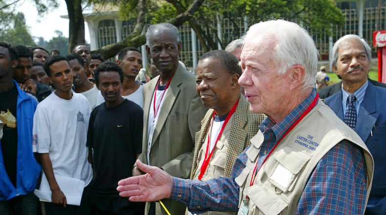 Former Tanzanian Prime Minister Joseph Warioba (fourth from left), former Botswanan President Ketumile Joni Masire (center) and former U.S. President Jimmy Carter address members of the media at a polling station at the university in Addis Ababa on May 15, 2005, during the third democratic elections in Ethiopia's 3,000-year history. (Karel Prinsloo/AP)