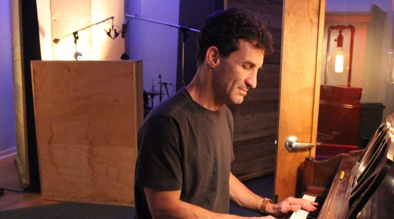 Producer/musician David Barbe plays piano in his Athens studio. Photo: Melissa Ruggieri/AJC