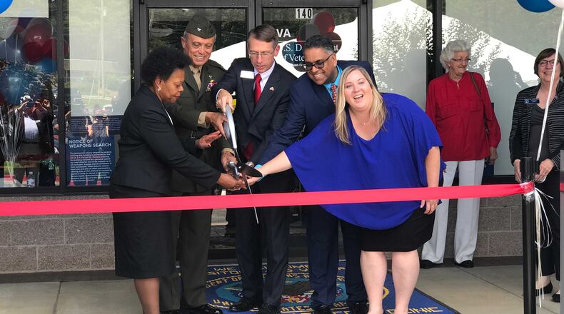 Local representatives and VA officials cut the ribbon on a new clinic in East Cobb. MERIS LUTZ / AJC