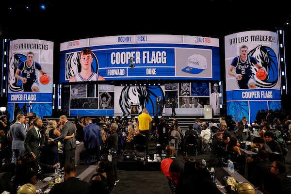 Cooper Flagg, right, poses for a photo with NBA commissioner Adam Silver after being selected first overall by the Dallas Mavericks In the first round of the NBA basketball draft, Wednesday, June 25, 2025, in New York. (AP Photo/Adam Hunger)