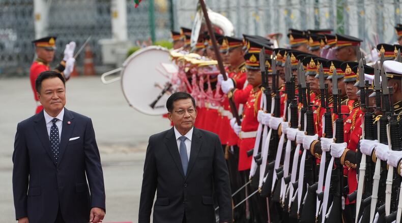Thailand's Prime Minister Anutin Charnvirakul, left, and Myanmar's President Min Aung Hlaing review an honor guard during a welcome ceremony at the Government House in Bangkok, Thailand Thursday, Aug. 6, 2026. (AP Photo/Sakchai Lalit)