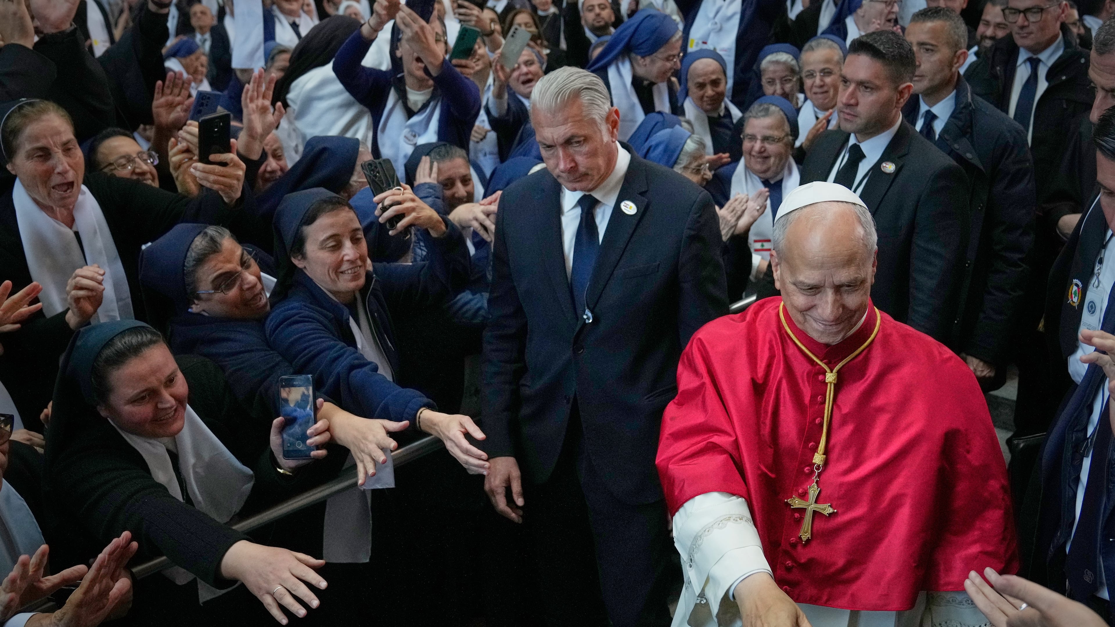 Pope Leo XIV is greeted as he arrives to meet with bishops, priests, consecrated persons and pastoral workers at the Catholic basilica of Harissa, Lebanon Monday, Dec. 1, 2025. (AP Photo/Hussein Malla)