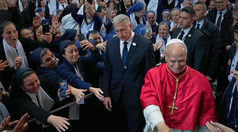 Pope Leo XIV is greeted as he arrives to meet with bishops, priests, consecrated persons and pastoral workers at the Catholic basilica of Harissa, Lebanon Monday, Dec. 1, 2025. (AP Photo/Hussein Malla)