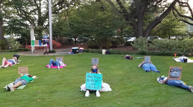 Protesters held a die-in at Georgia College on Friday, Aug. 28, 2020 to publicize demands, such as allowing any student and faculty to participate in classes remotely, to prevent the spread of COVID-19 on campus. Georgia College has reported more than 500 positive cases since it began tracking cases in mid-June. PHOTO CREDIT: United Campus Workers of Georgia - Georgia College