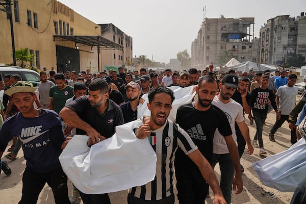 Palestinians carry the bodies of their relatives killed in an Israeli army airstrike, during their funeral in Khan Younis, Gaza Strip, Sunday, May 18, 2025. (AP Photo/Abdel Kareem Hana)