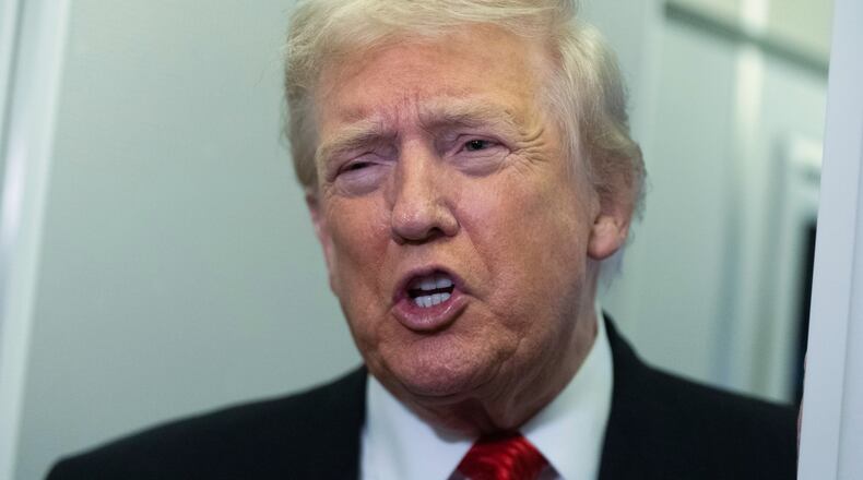 President Donald Trump speaks to reporters on board Air Force One on his way back to the White House from a weekend trip at his Mar-a-Lago estate in Palm Beach, Fla., Sunday, Nov. 2, 2025. (AP Photo/Manuel Balce Ceneta)