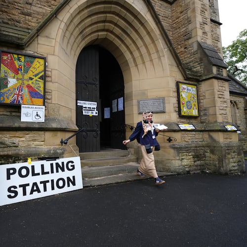 A voter leaves a polling station at St Chrysostom's Church, as voting gets underway in the Greater Manchester mayoral by-election, in Manchester, England, Thursday July 30, 2026. (Annabelle Lee-Ellis/PA via AP)