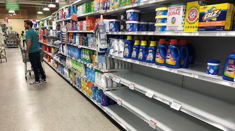 Shortages of particular items have hit grocery store shelves as people have engaged in some hoarding and panic-induced buying because of the spread of COVID-19. In this Publix in Cobb County, all the bleach, which can be used for sanitizing, has been purchased, though the shelves remain full of other clothes cleaning products. Christopher Quinn