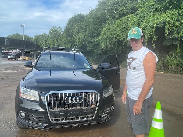 Friday's storm washed the front license plat off of David Turrentine's car. His car was one of several damaged. (Chaya Tong/AJC)