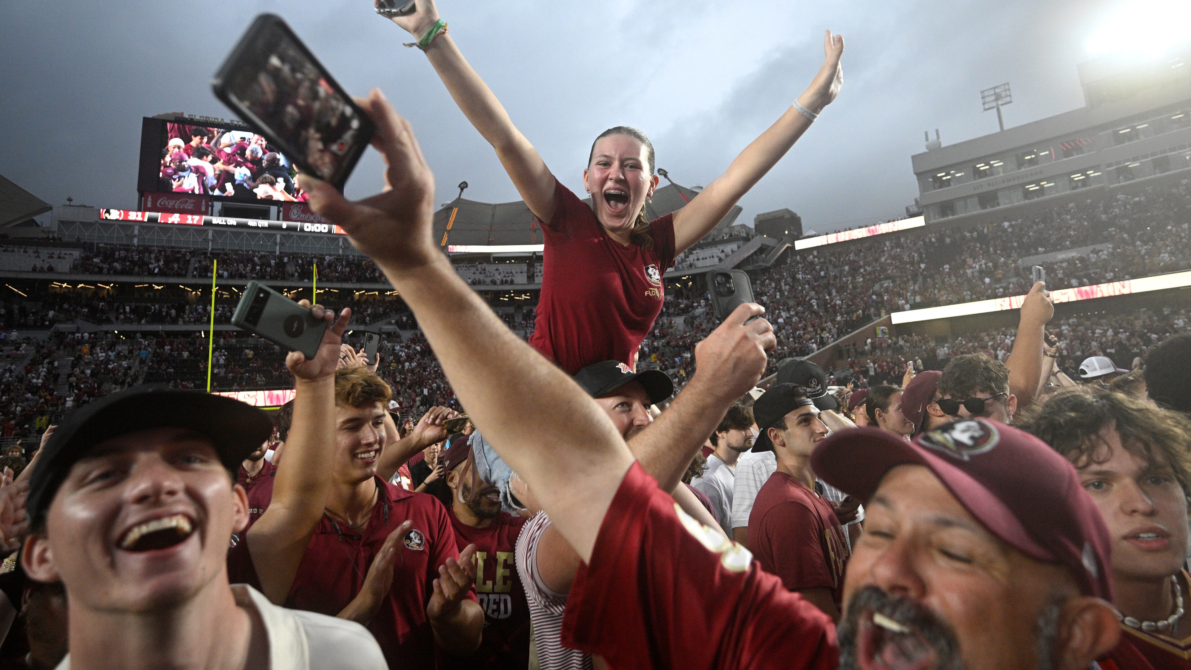 Florida State fans celebrate on the field after a win against Alabama in an NCAA college football game, Saturday, Aug. 30, 2025, in Tallahassee, Fla. (AP Photo/Phelan M. Ebenhack)