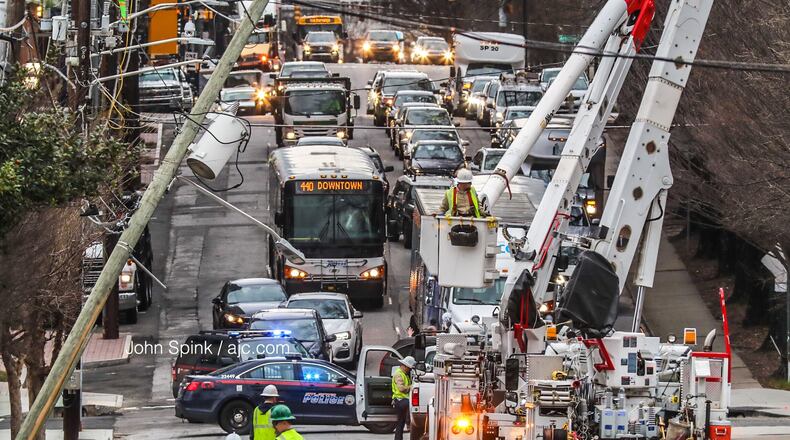 Police temporarily shut down all of Spring Street at Third Street after a vehicle hit and snapped a power pole.