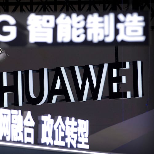 FILE - Signs promoting 5G wireless technology from Chinese technology firm Huawei are displayed at the PT Expo in Beijing on Sept. 26, 2018. (AP Photo/Mark Schiefelbein, File)