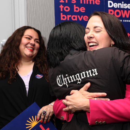 Denise Powell, candidate for the Democratic nomination to the House of Representatives in Nebraska's second district, right, hugs Jennifer Reyna, chair of Latino Caucus for the Democratic Party of Nebraska, during an election night watch party Wednesday, May 13, 2026, in Omaha, Neb. (AP Photo/Rebecca S. Gratz)
