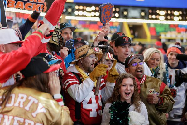 San Francisco 49ers and Chicago Bears fans cheer during the second round of the NFL football draft, Friday, April 25, 2025, in Green Bay, Wis. (AP Photo/Matt Ludtke)