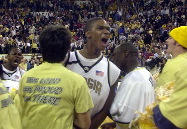 Georgia Tech's Chris Bosh celebrates as students rush the floor after the Yellow Jackets defeated Georgia 83-77 in Atlanta, Wednesday, Nov., 27, 2002. Bosh scored 16 points. (AP Photo/John Bazemore)
