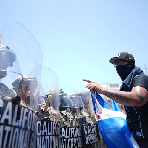 FILE - A protester confronts a line of U.S. National Guard in the metropolitan detention center of downtown Los Angeles, June 8, 2025, following last night's immigration raid protest. (AP Photo/Eric Thayer, File)
